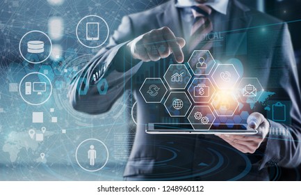 Manager Technical Industrial Engineer working and control robotics with monitoring system software and icon industry network connection on tablet. AI, Artificial Intelligence, Automation robot arm.
