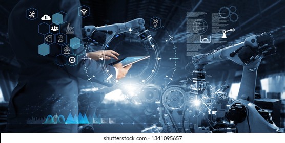 Manager Technical Industrial Engineer working and control robotics with monitoring system software and icon industry network connection on tablet. AI, Artificial Intelligence, Automation robot arm
