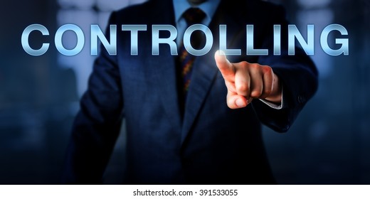 Manager touching CONTROLLING on an interactive screen. Business metaphor and managerial control concept for performance measurement in relation to predetermined corporate standards, goals and plans.