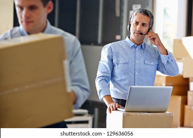 Manager Using Headset In Distribution Warehouse - Powered by Shutterstock