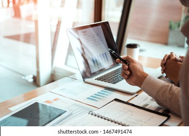 Manager is using a laptop computer while analyzing the company's financial statements on the screen. - Shutterstock ID 1467491474