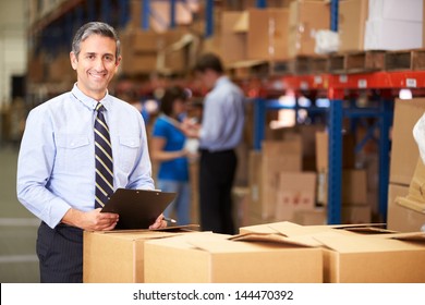 Manager In Warehouse Checking Boxes - Powered by Shutterstock