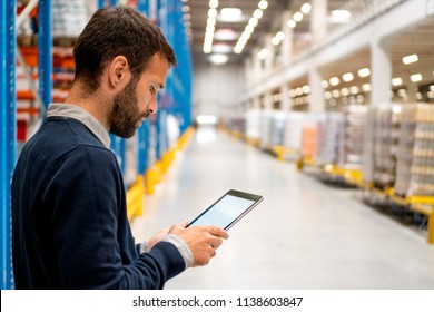 Manager in warehouse holding digital tablet - Shutterstock ID 1138603847