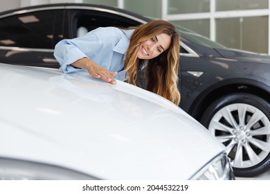 Manager Woman Customer Female Buyer Client Wears Blue Shirt Touch Hood Check Quality Chooses Auto Want Buy New Automobile In Car Showroom Vehicle Salon Dealership Store Motor Show Indoor Sales Concept