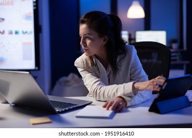 Manager Woman Using Laptop And Tablet In Same Time Working On Financial Reports In Business Start-up Office . Busy Multitasking Employee Using Modern Technology Network Wireless Late At Night