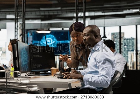 Manager and IT worker testing AI machine learning algorithms at work. Team leader supervising engineer scaling productivity with artificial intelligence large language model technology