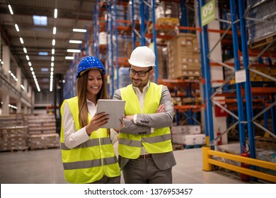 Managers controlling distribution and checking inventory in warehouse storage. - Powered by Shutterstock - Get 15% off with code: PIKWIZARD15