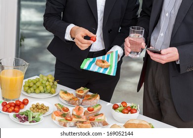 Managers at office buffet during business lunch