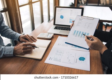 Managers Are Using Tablets To Analyze Sales Cost Reports And Explain Summary Reports To Employees Calculate And Record Summary Information Data In The Office.