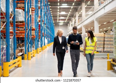 Managers visit warehouse - Shutterstock ID 1121870357