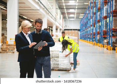 Managers in Warehouse discuss about business strategy - Powered by Shutterstock