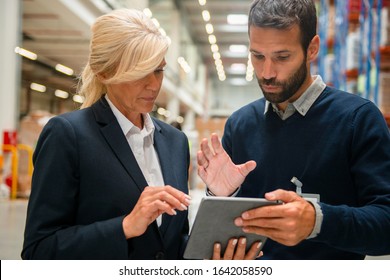 Managers in Warehouse discuss about business strategy - Powered by Shutterstock