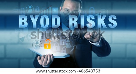 Managing director is touching BYOD RISKS on a virtual touch screen interface. Business phenomenon metaphor and information technology concept for Bring Your Own Device and IT consumerization.