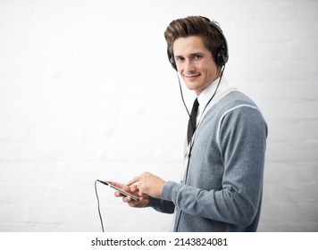 Managing His Playlist. A Young Nerdy Guy Holding An Mp3 Player.