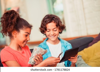 Managing money. A boy and a girl learning to plan a budget - Powered by Shutterstock