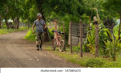 Managua, Nicaragua - June 21, 2018: Man Walking On A Dirt Road In A Rural Barrio. Poverty And Political Crisis Of Third World Nation In Central America.