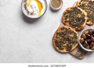 Manakeesh, arabic pizza, flat bread topped with zaatar spices, copy space. Homemade  mediterranean flat bread manakish.