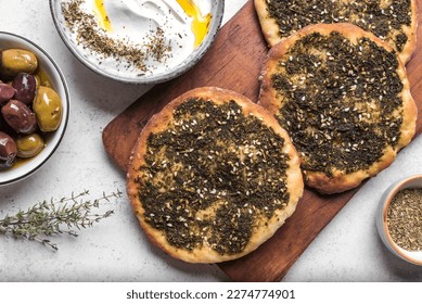 Manakeesh, arabic pizza, flat bread topped with zaatar spices close up. Homemade  mediterranean flat bread manakish for breakfast.