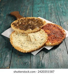 Manakeesh, arabic pizza, flat bread topped with zaatar spices close up. Homemade mediterranean flat bread manakish for breakfast