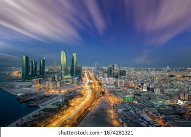 Manama, Bahrain - December 14, 2020: Aerial view of Manama skyline with iconic Bahrain Financial Harbour and Bahrain World Trade Center building during blue hour with beautiful clouds.