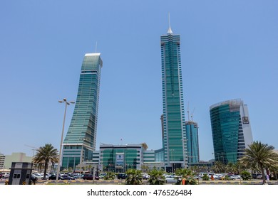 Manama, Bahrain - July 09, 2016: People parking in front of the Financial Harbour Gate towers in Manama for shopping. 