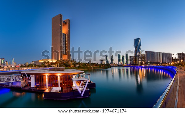 MANAMA,\
BAHRAIN - May 16, 2021: Panoramic view of Bahrain Bay and  Four\
Seasons Hotel with a floating restaurant V Lounge in the foreground\
at blue hour - Long Exposure, Motion Blur\
image