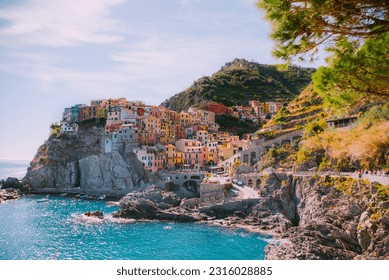 Manarola is a picturesque town in Italy known for its colorful buildings and beautiful views of the Mediterranean sea, making it the perfect destination for a summer vacation filled with nature .