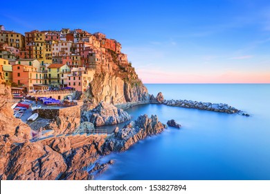 Manarola village on cliff rocks and sea at sunset., Seascape in Five lands, Cinque Terre National Park, Liguria Italy Europe. Long Exposure Photography.