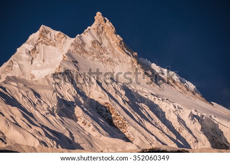 Manaslu mountain as viewed in its full glory at sunrise from a small Tibetan village of Samagaon, located on the trail of the famous Around Manaslu trek, Manaslu Himal, Nepalese Himalyas, Nepal  