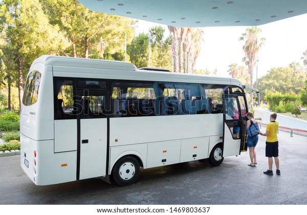 \
Manavgat, Turkey, 09/07/2019 Bus and people\
near the hotel. editorial Residents of the hotel board the bus and\
leave for the\
airport.