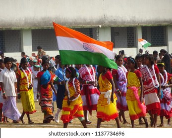 Manbazar, West Bengal / India - 26th January 2018 : Indian Under Privileged Tribal School Girls Holding And Waving National Flag And Performing Dance At Republic Day Parade And Celebration