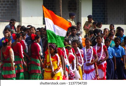 Manbazar, West Bengal / India - 26th January 2018 : Indian Under Privileged Tribal School Girls Holding And Waving National Flag And Performing Dance At Republic Day Parade And Celebration