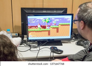 MANCHESTER, ENGLAND - APRIL 14, 2019: Attendee playing Sonic the Hedgehog on the Sega Master System at the Manchester Anime and Gaming Convention