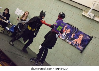 MANCHESTER, ENGLAND - APRIL 2, 2016: Deadpool and Batman Cosplayers pose at the Manchester Anime and Gaming Convention