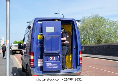 Manchester, England - April 20, 2022. G4s Vehicle With Security Guard Closing The Door. Cash In Transit Services. Van Parked Near Manchester United Stadium.