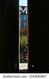 Manchester, England - August 12 2022: View Down Narrow Alleyway Behind Rochdale Canal Looking Down Onto Whitworth Street On Sunny Day During Heatwave