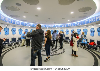 MANCHESTER - ENGLAND, MAY 16, 2019 : A Group Tour With Player's Jerseys Hung In Front Of Lockers In The Changing Room At Etihad Stadium; The Home Ground Of Manchester City Football Club.