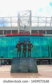 MANCHESTER, ENGLAND - MAY 16, 2019: The United Trinity refers to the Manchester United trio of George Best, Denis Law, and Sir Bobby Charlton at Old Trafford stadium; home ground of Manchester United.