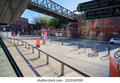 Manchester, England, UK - 10/02/2019: Manchester Central Street, With Street Furniture Thats To The Rear Of Deansgate-Castlefield Metro Station, With View Of Deansgate Railway Station And Linking Brid