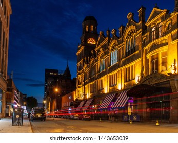 Manchester, England, UK - July 1, 2018: Traffic Leaves Light Trails On Peter Street Outside Albert Hall, A Former Methodist Central Hall Turned Nightclub And Music Venue In Manchester's City Centre.