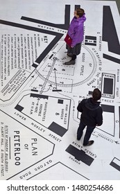 Manchester Greater Manchester UK August 16 2019  200th Anniversary Of Peterloo Massacre Aerial View Map Of The Day  With Man And Woman Studying