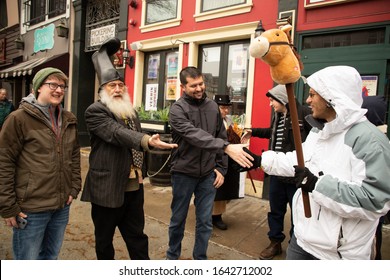 MANCHESTER, NEW HAMPSHIRE, USA - FEBRUARY 11, 2020: A Libertarian 2020 Presidential Candidate Known As Vermin Supreme, Second From Left, Is Seen In Downtown Manchester, New Hampshire.