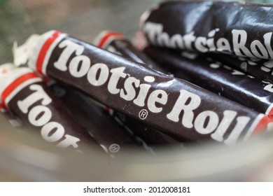 MANCHESTER, NH - July 13, 2021: Close Up Photo Of Tootsie Rolls In Their Classic Wax Paper Wrappers