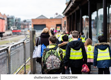 Manchester, Uk - 1st March 2018 - A Group Of School Children Walking In The Street On A School Trip Wearing High Visibility Jackets For Safety