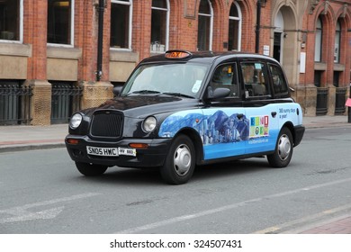 MANCHESTER, UK - APRIL 22, 2013: Taxi cab drives in Manchester, UK. There are 242,200 taxi and private hire licences in England (as of March 2015).