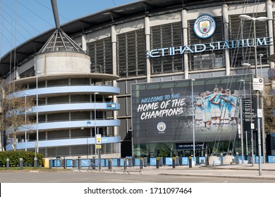 Manchester UK. April 22, 2020. Etihad Stadium, Manchester City Football Club during the coronavirus lockdown. Entrance to the Colin Bell stand with display screen showing team huddle