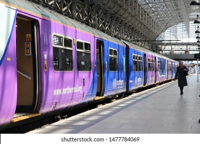 MANCHESTER, UK - APRIL 23, 2013: People Walk By Northern Rail Train In Manchester, UK. NR Is Part Of Serco-Abellio Joint Venture. NR Has Fleet Of 313 Trains And Calls At 529 Stations.