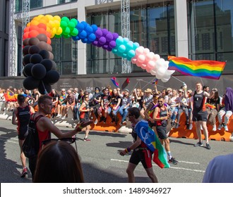 Manchester, UK - August 24, 2019: Manchester Pride Parade 2019. Group Representing Frontrunners With Hovering Rainbow Balloon Arch Finish Line.