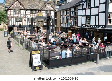 Manchester UK. August 24, 2020. Eat Out To Help Out Scheme. Crowd Outside Sinclairs Oyster Bar. Sandwich Board With Advert For Scheme Participation.