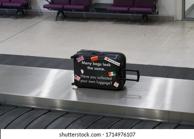 Manchester, UK - February 19 2020: UK Airport Baggage Reclaim Area Security Reminder. Manchester Airport Terminal Arrivals Empty Luggage Carousel With Message For Collecting Your Personal Bag.